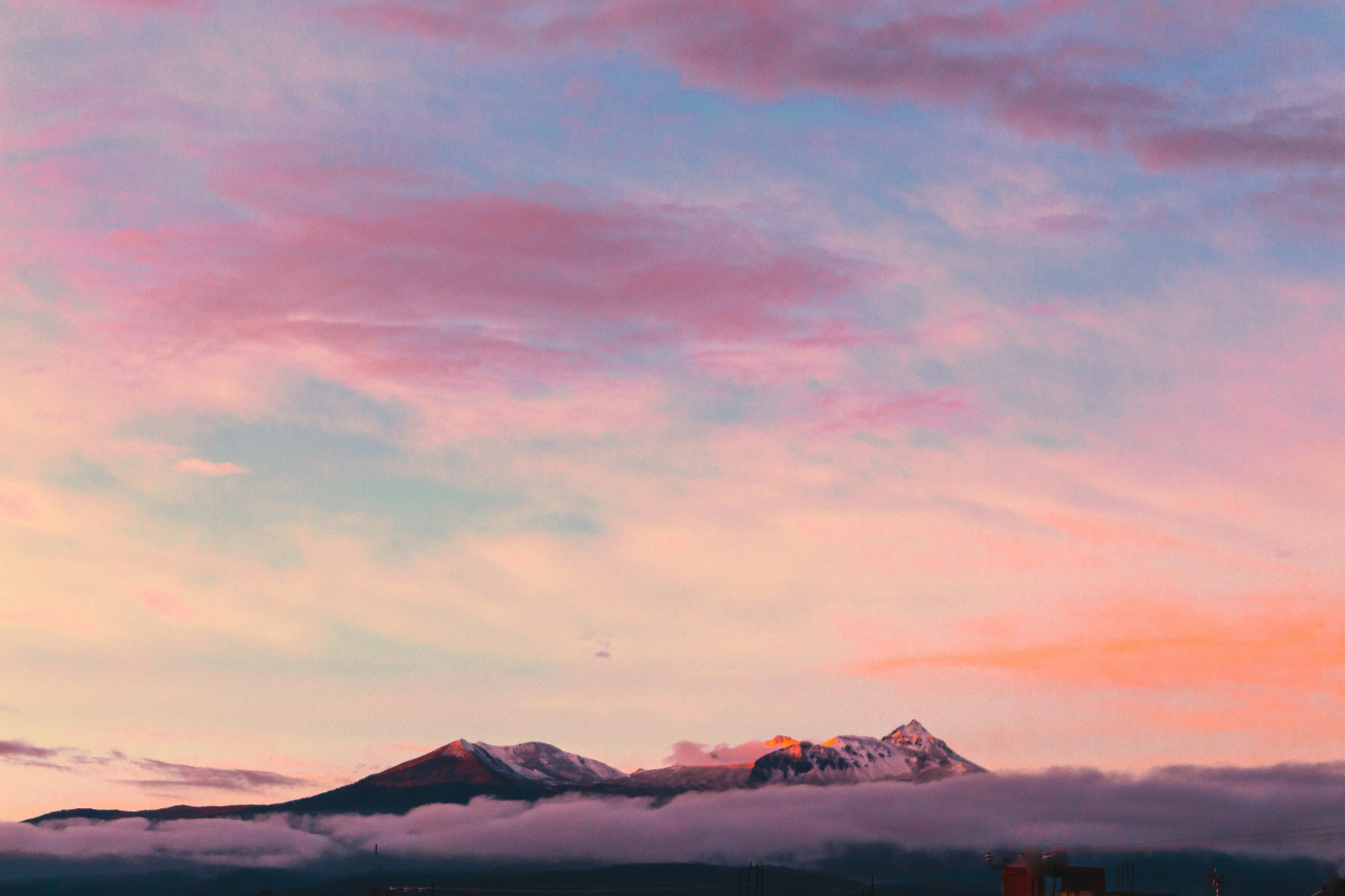 aerial photography of mountain under clouds during golden hour